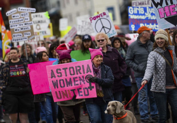 Marchers walk throughout downtown during the Astoria Women's March held on Saturday, Jan. 21, 2017, in Astoria, Ore. (Danny Miller/The Daily Astorian via AP) NYTCREDIT: Danny Miller/Daily Astorian, via Associated Press