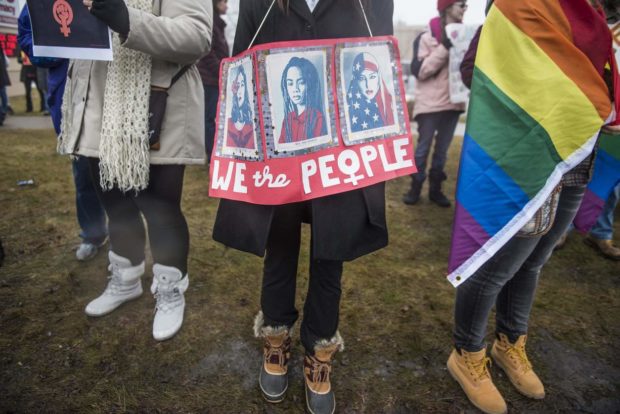 People hold signs of equality and empowerment at the Women's March in Midland on Saturday, Jan. 21, 2017. The march was hosted by The Women of Michigan Action Network (WOMAN) in solidarity with other women's marches around the globe.(Heather Khalifa/The Saginaw News via AP) NYTCREDIT: Heather Khalifa/The Saginaw News, via Associated Press