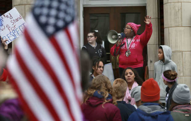 La Tasha Do'zia Earley (with megaphone) address those attending the Winchester Women's March held Saturday Jan. 21, 2017, in downtown Winchester, Va. (Ginger Perry/The Winchester Star via AP) NYTCREDIT: Ginger Perry/The Winchester Star, via Associated Press