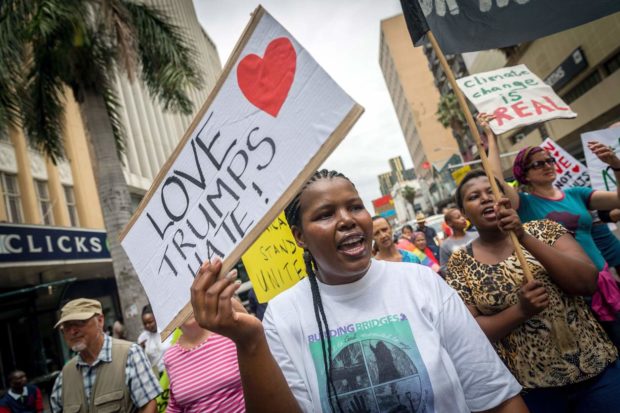 Anti-Trump protesters shout slogans and hold placards against the newly sworn United States of America president Donald Trump during a demonstration organized by Earthlife Africa in the central streets of Durban following his inauguration on January 21, 2017 in Durban, South Africa. / AFP PHOTO / RAJESH JANTILALRAJESH JANTILAL/AFP/Getty Images NYTCREDIT: Rajesh Jantilal/Agence France-Presse -- Getty Images