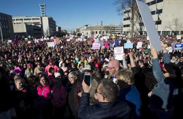 Marchers join arms and sing at the end of the Women's March outside the capitol in Lincoln, Neb., Saturday, Jan. 21, 2017. (Jake Crandall/The Journal-Star via AP) NYTCREDIT: Jake Crandall/The Journal-Star, via Associated Press