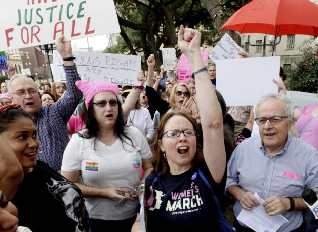 Debbie Hollis, center, marches and chants during the Women's March outside the Caddo Parish Courthouse in Shreveport, La., Saturday, Jan. 21, 2017. (Henrietta Wildsmith/The Shreveport Times via AP) NYTCREDIT: Henrietta Wildsmith/The Shreveport Times, via Associated Press