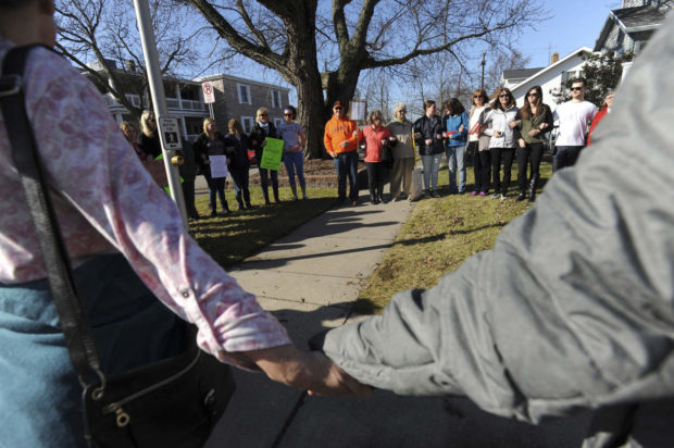 Dozens of people link arms as they gather along Main Street in St. Joseph, Mich., Saturday, Jan. 21, 2017, for a sister march held to show unity with the Women's March on Washington.(Don Campbell/ The Herald-Palladium via AP) NYTCREDIT: Don Campbell/The Herald-Palladium, via Associated Press
